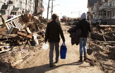 Volunteers walk to help victims affected by hurricane.