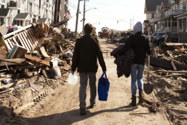 Volunteers walk to help victims affected by hurricane.