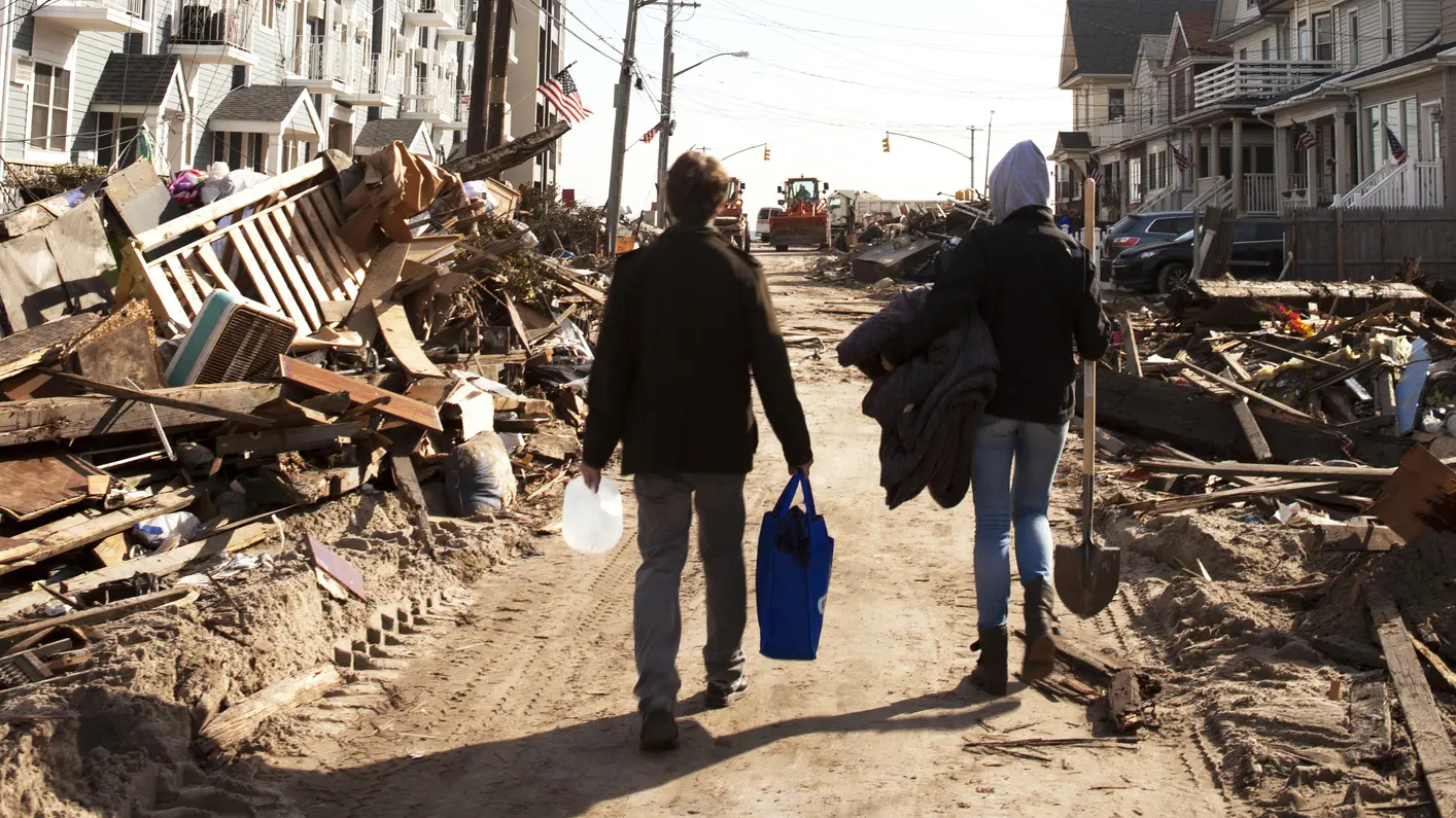 Volunteers walk to help victims affected by hurricane.